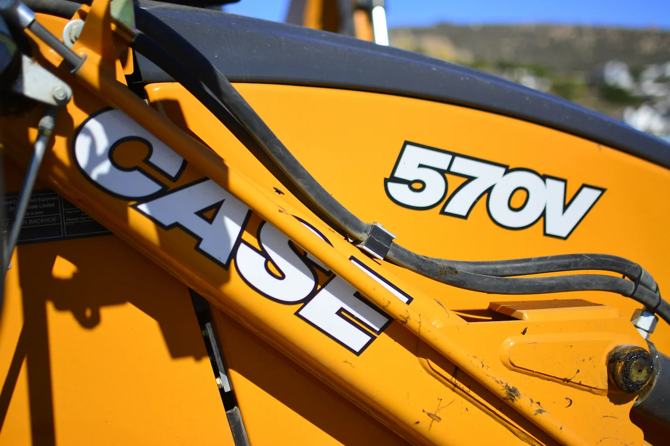 Close-up of Superior Plant Hire digger loader branding and model number