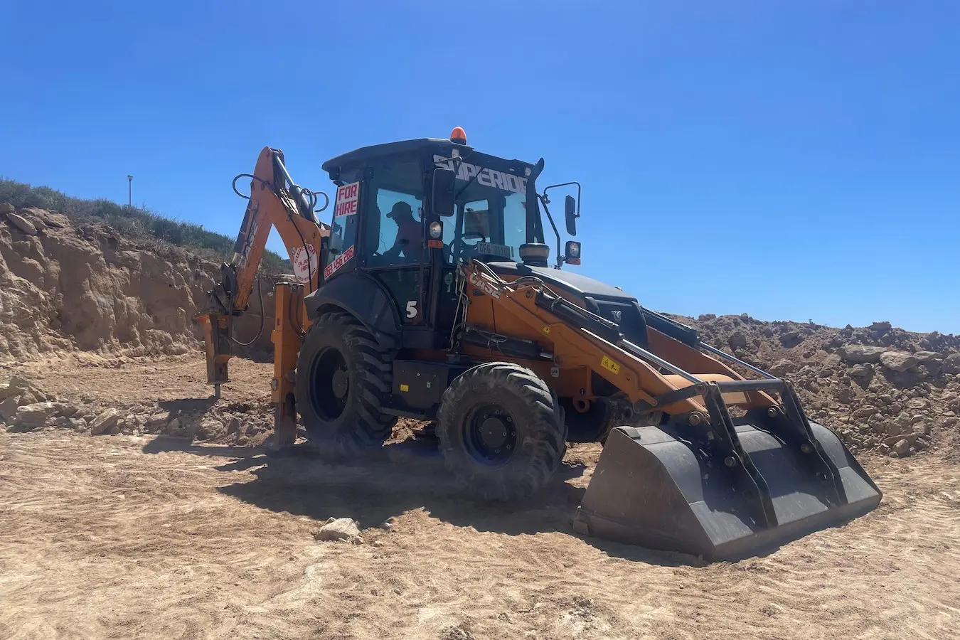Digger loader pecker attachment breaking concrete