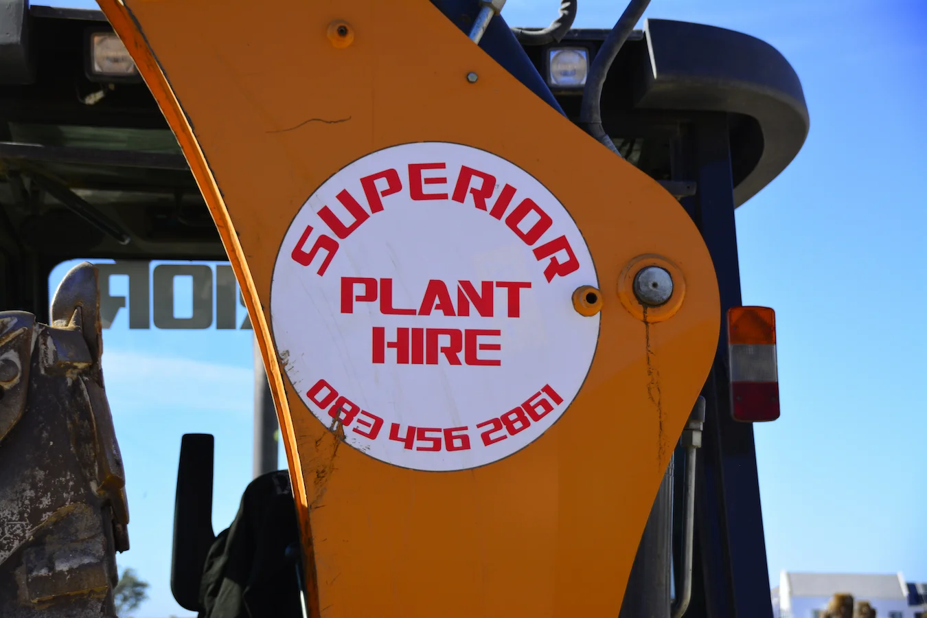 Close-up of the Superior Plant Hire logo sticker on a digger loader